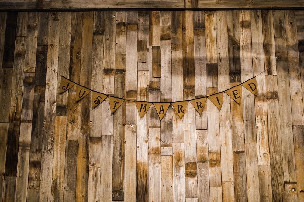 Just Married Banner on Rustic Wood Wall | 7 Key Questions to Ask Your Venue Before Booking | Mill Pond Farms Event Center | How Soon Should You Enquire About a Venue