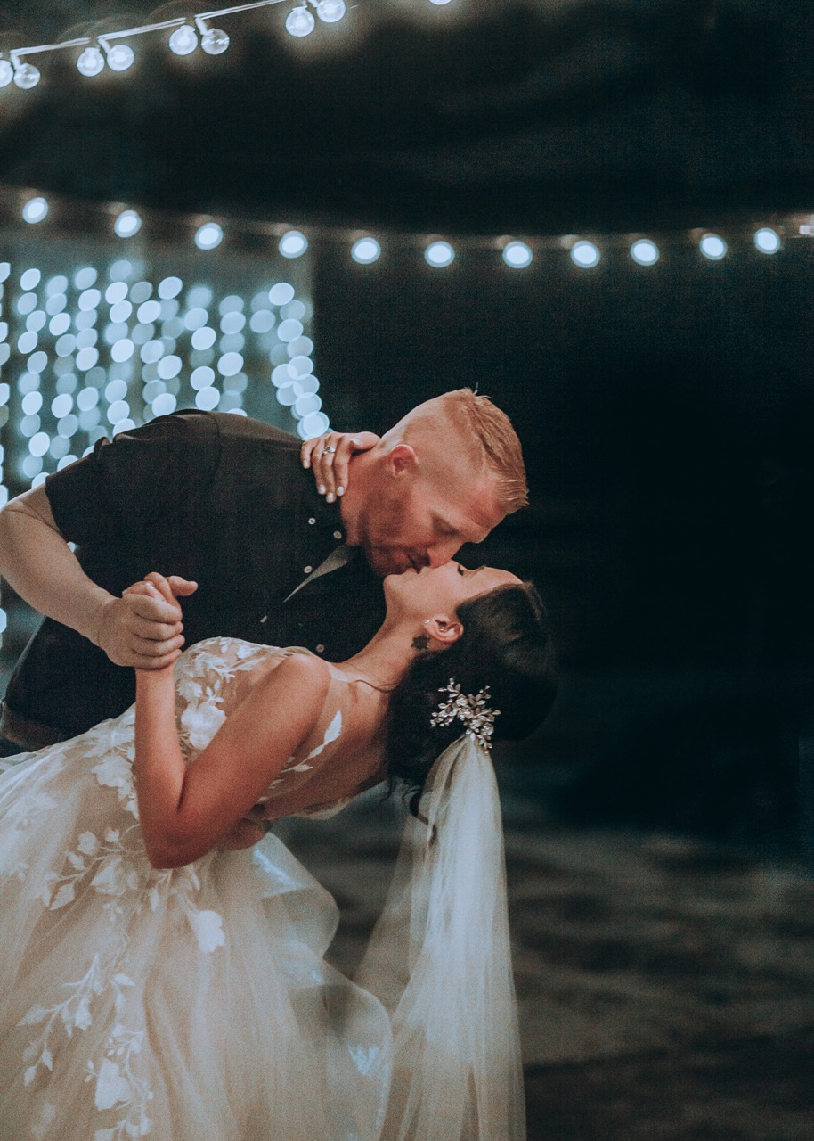 Bride & Groom Kissing in Outdoor Wedding Utah | Mill Pond Farms | Decorating Outdoor Wedding Tent | Outdoor Wedding and Rain