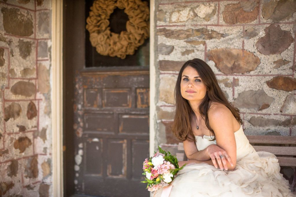 Bride In Front of Brown Toned Stone House | The Coulter House History | Transforming Coulter House to Mill Pond Farms Events