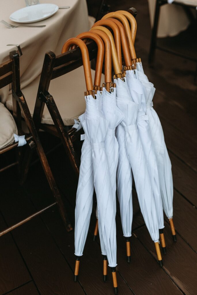 White Umbrellas with Wooden Handles | Outdoor Wedding Tips: Wedding Day Essentials to Consider | Planning for Wedding Guest