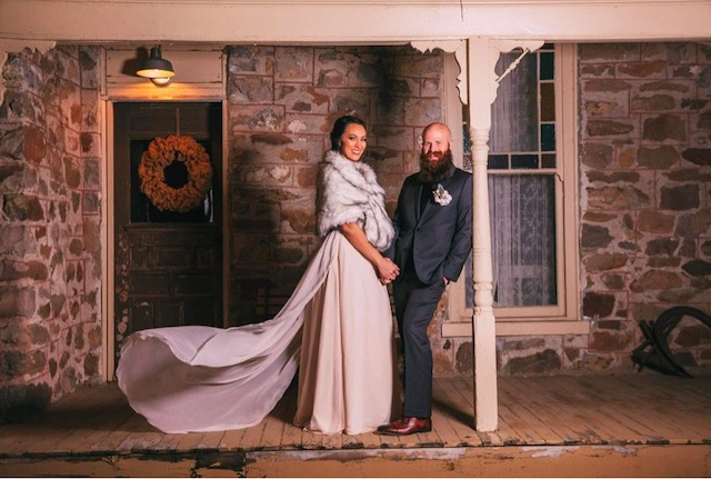 Winter Bride & Groom Portrait In Front of Mill Pond Farms Events Center | Winter Formal Outdoor Wedding Attire for Guests